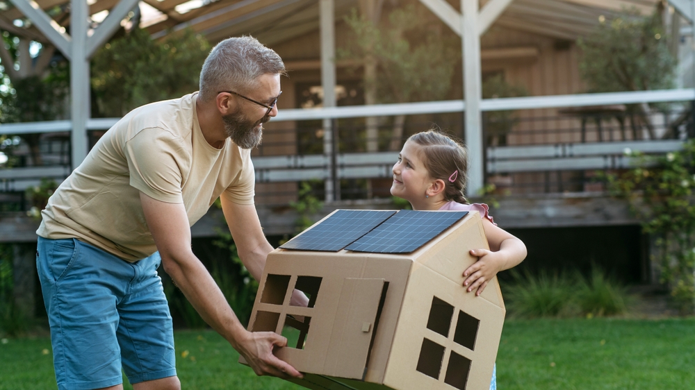 Dad,And,Girl,Playing,With,House,With,Solar,Panels,On